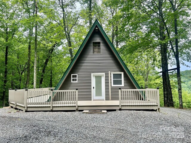 back of property featuring a wooden deck
