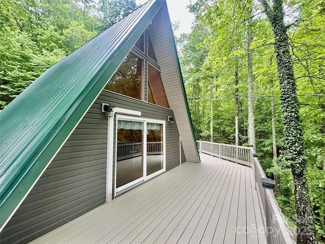 wooden deck with a view of trees