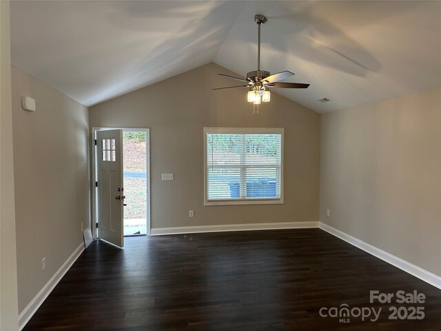 entrance foyer with lofted ceiling, ceiling fan, dark wood-type flooring, and baseboards