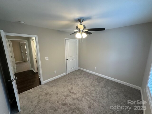 unfurnished bedroom with carpet flooring, baseboards, and a ceiling fan