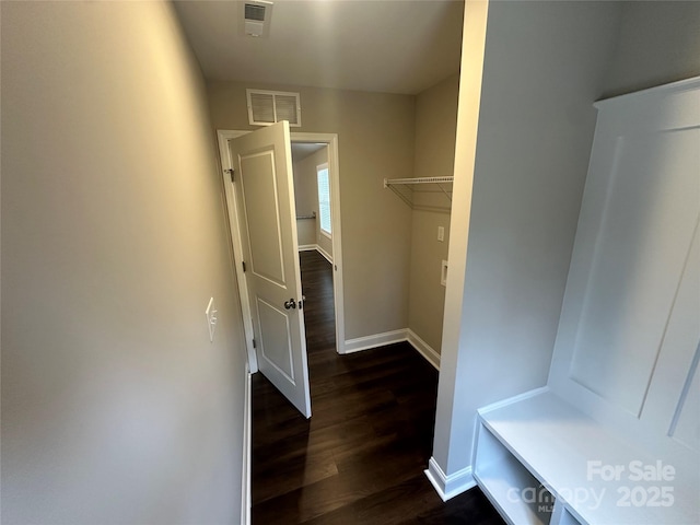 mudroom featuring dark wood-style floors and baseboards