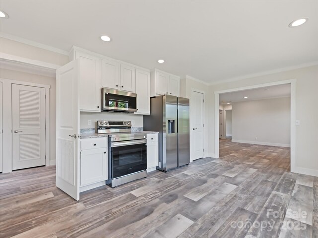 255 Thompson Cove Rd, Clyde, NC 28721 - kitchen with stainless steel appliances, white cabinets, light wood finished floors, baseboards, and recessed lighting