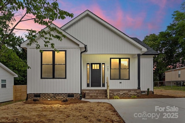 view of front of home with crawl space, fence, and entry steps