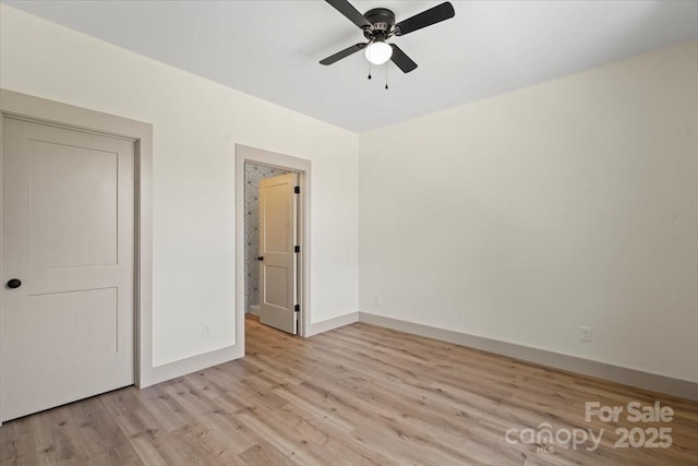 unfurnished bedroom featuring light wood-type flooring, baseboards, and a ceiling fan