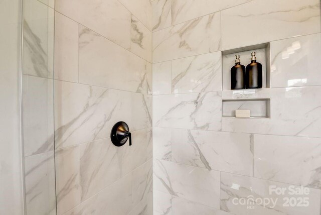 bathroom with a tile shower