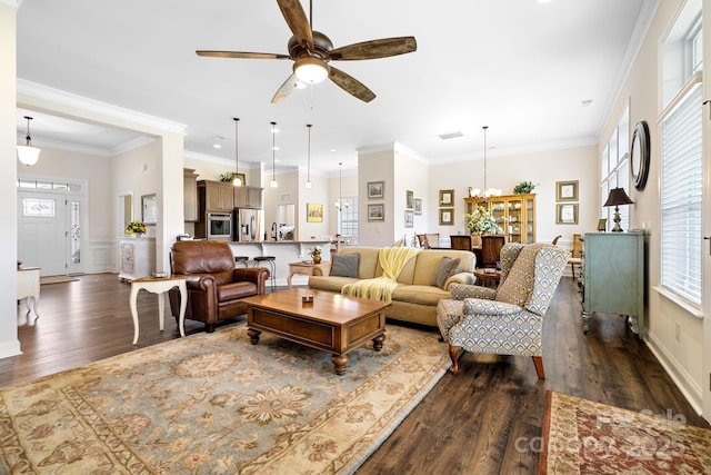 7016 Bareland Rd, Fort Mill, SC 29707 - living room featuring plenty of natural light, dark wood-type flooring, ceiling fan, a chandelier, and crown molding