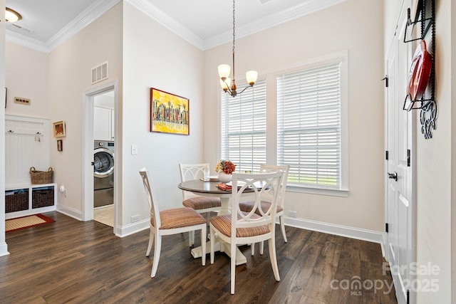 7016 Bareland Rd, Fort Mill, SC 29707 - dining room featuring crown molding, dark wood finished floors, baseboards, a chandelier, and washer / dryer