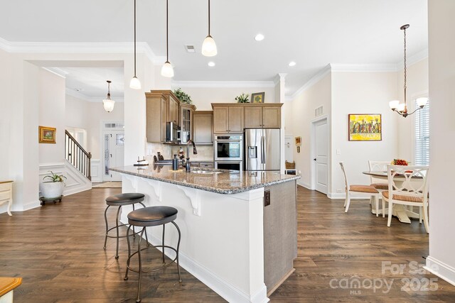 7016 Bareland Rd, Fort Mill, SC 29707 - kitchen featuring appliances with stainless steel finishes, a breakfast bar, a sink, glass insert cabinets, and stone countertops