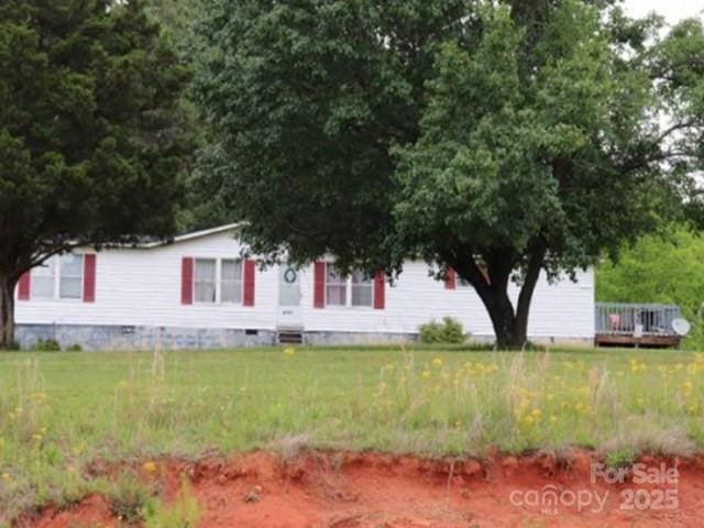 view of front of property with crawl space, a front lawn, and a wooden deck