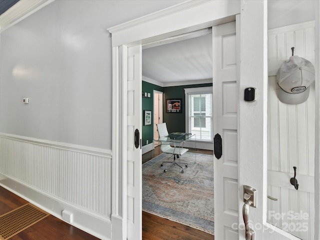 office space with wood finished floors and ornamental molding