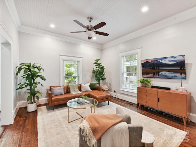 living area with healthy amount of natural light, wood finished floors, a ceiling fan, recessed lighting, and baseboards
