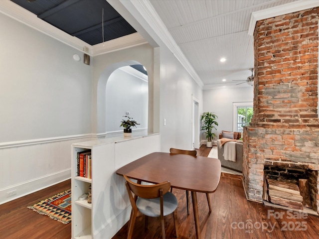 dining area featuring wood finished floors, ceiling fan, ornamental molding, arched walkways, and recessed lighting