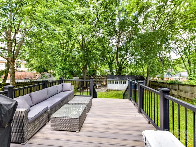 wooden deck featuring outdoor lounge area and an outbuilding
