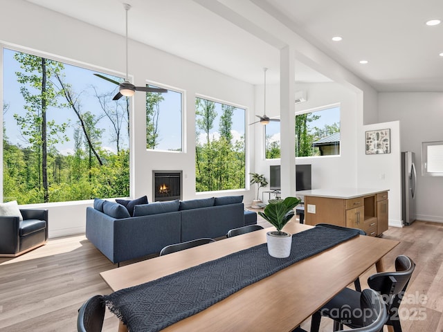85 S Fork Trl, Lake Toxaway, NC 28747 - dining area with ceiling fan, recessed lighting, light wood-type flooring, and a warm lit fireplace
