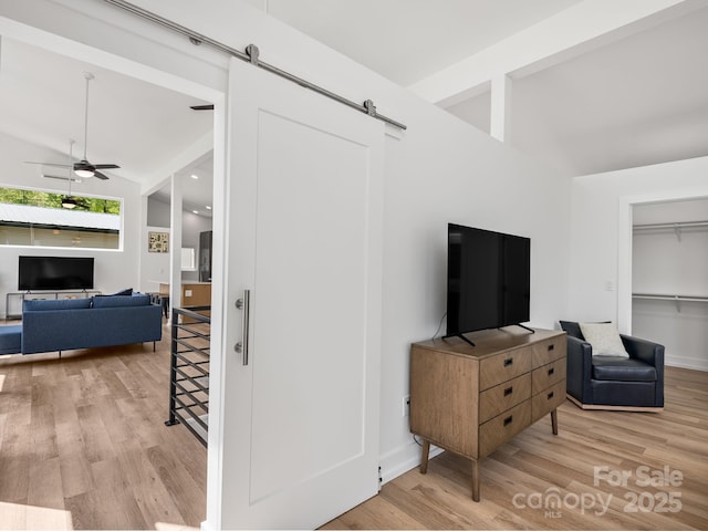 85 S Fork Trl, Lake Toxaway, NC 28747 - living area featuring a barn door, wood finished floors, ceiling fan, and baseboards