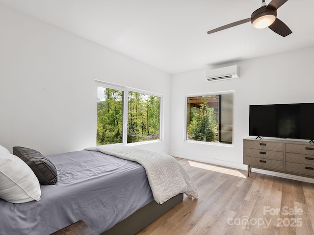 85 S Fork Trl, Lake Toxaway, NC 28747 - bedroom with a wall mounted AC, wood finished floors, and ceiling fan