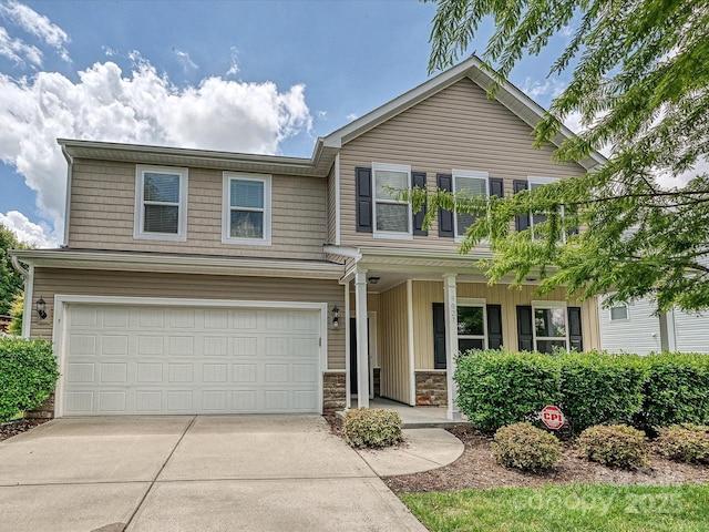 9027 Gray Willow Rd, Charlotte, NC 28227 - traditional-style house featuring covered porch, concrete driveway, a garage, and stone siding