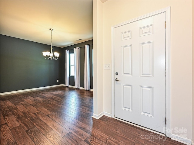9027 Gray Willow Rd, Charlotte, NC 28227 - foyer entrance with a chandelier, dark wood finished floors, and baseboards