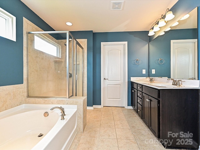 9027 Gray Willow Rd, Charlotte, NC 28227 - bathroom with a garden tub, a stall shower, double vanity, tile patterned floors, and baseboards