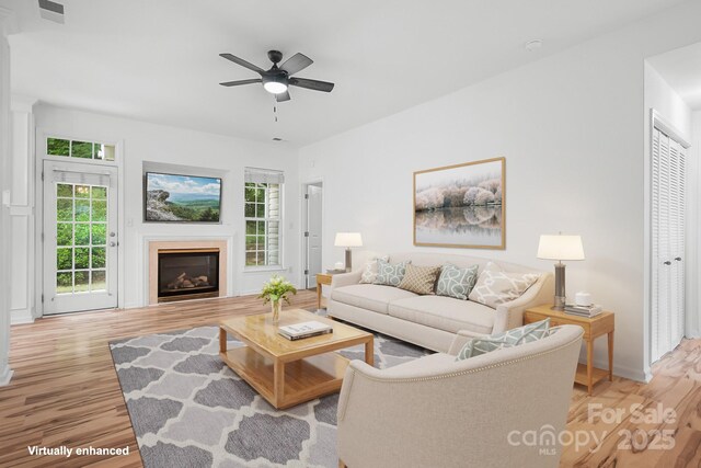4719 Sahalee Ln, Charlotte, NC 28216 - living area with light wood-type flooring, ceiling fan, and a glass covered fireplace