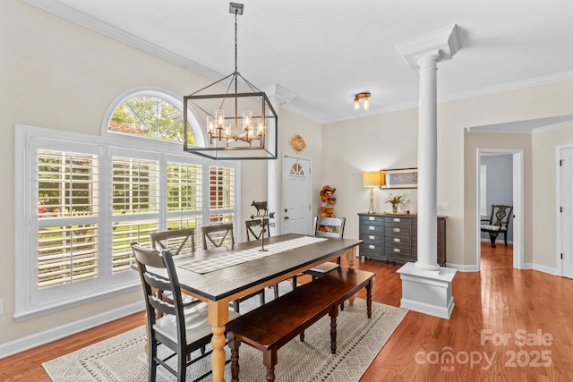 149 Harbor Landing Dr, Mooresville, NC 28117 - dining area with ornate columns, light wood finished floors, ornamental molding, baseboards, and a chandelier