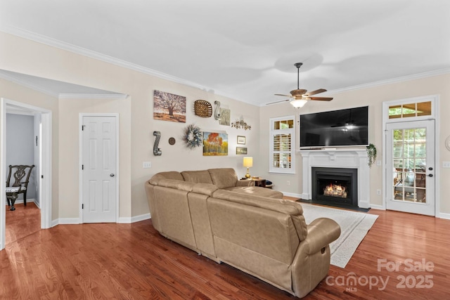 149 Harbor Landing Dr, Mooresville, NC 28117 - living room featuring ornamental molding, a fireplace with flush hearth, wood finished floors, ceiling fan, and baseboards