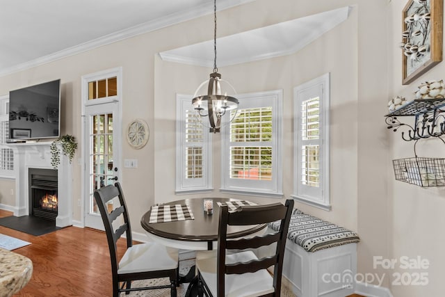 149 Harbor Landing Dr, Mooresville, NC 28117 - dining room with a chandelier, crown molding, wood finished floors, baseboards, and a fireplace with flush hearth
