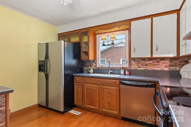 1405 8th Ave NW, Conover, NC 28613 - kitchen with dishwasher, stainless steel refrigerator with ice dispenser, a sink, tasteful backsplash, and light wood-style flooring