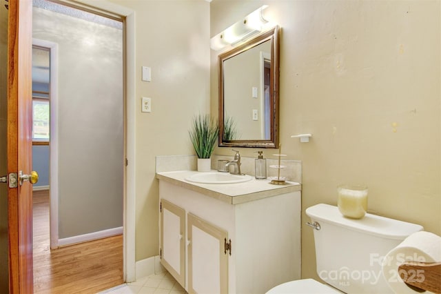 1405 8th Ave NW, Conover, NC 28613 - bathroom with vanity, toilet, wood finished floors, and baseboards