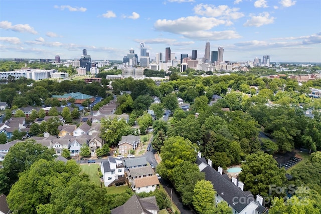drone / aerial view of a view of skyline and a tree filled landscape