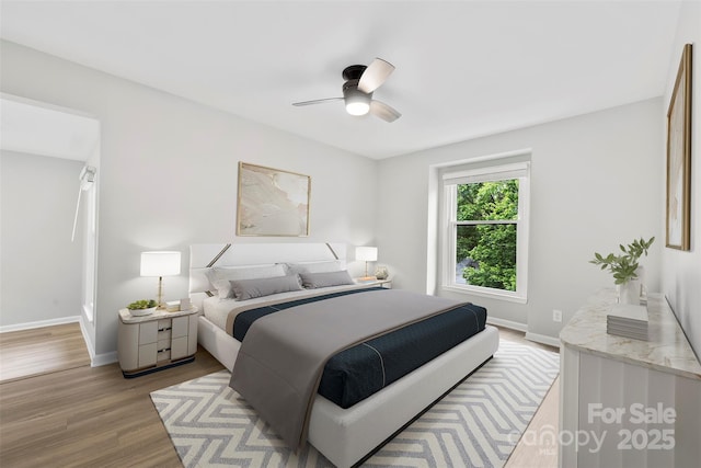 bedroom featuring wood finished floors, baseboards, and ceiling fan