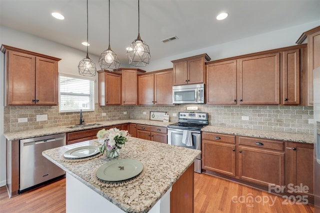 1412 Afternoon Sun Rd, Matthews, NC 28104 - kitchen featuring appliances with stainless steel finishes, light wood-style floors, brown cabinets, and recessed lighting