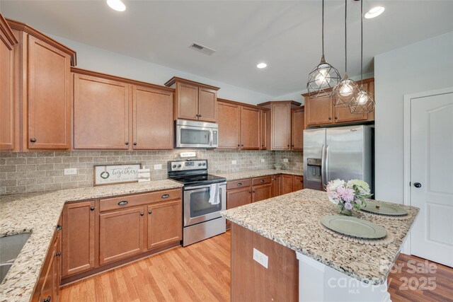 1412 Afternoon Sun Rd, Matthews, NC 28104 - kitchen featuring stainless steel appliances, light wood-style flooring, backsplash, light stone countertops, and recessed lighting