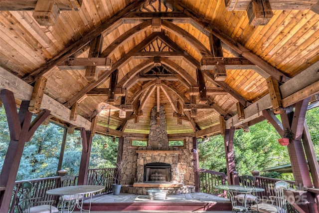 view of patio featuring an outdoor stone fireplace and a gazebo