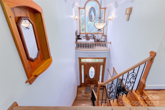 entrance foyer featuring wood finished floors, stairway, and baseboards