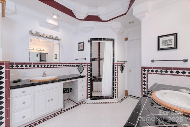 full bath featuring tile walls, vanity, ornamental molding, tile patterned flooring, and a shower stall