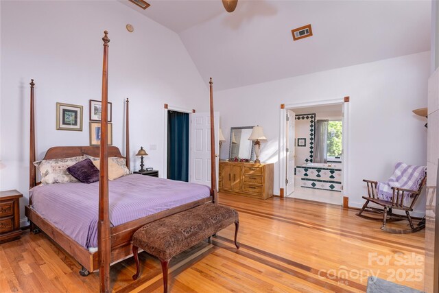 bedroom featuring light wood finished floors, high vaulted ceiling, and a ceiling fan