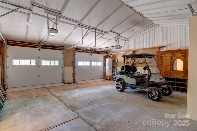 garage with a garage door opener and water heater