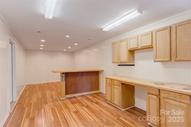 kitchen with light brown cabinets, light wood-style floors, recessed lighting, baseboards, and light countertops