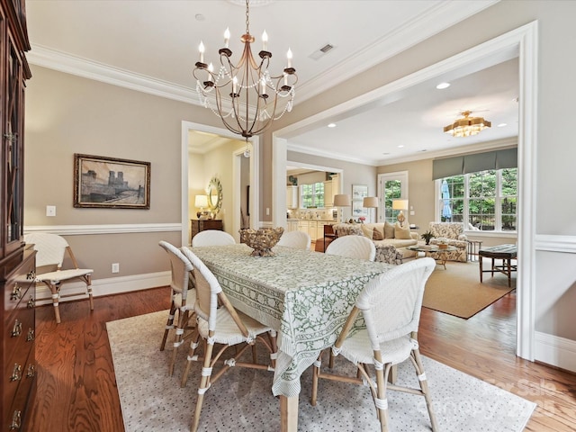 6128 Fletcher Cir, Charlotte, NC 28226 - dining room featuring a chandelier, crown molding, wood finished floors, baseboards, and recessed lighting