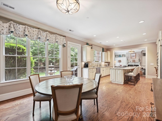 6128 Fletcher Cir, Charlotte, NC 28226 - dining area featuring crown molding, light wood-style floors, baseboards, and recessed lighting