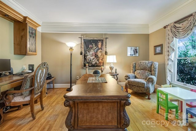office space with crown molding, light wood-style flooring, and baseboards