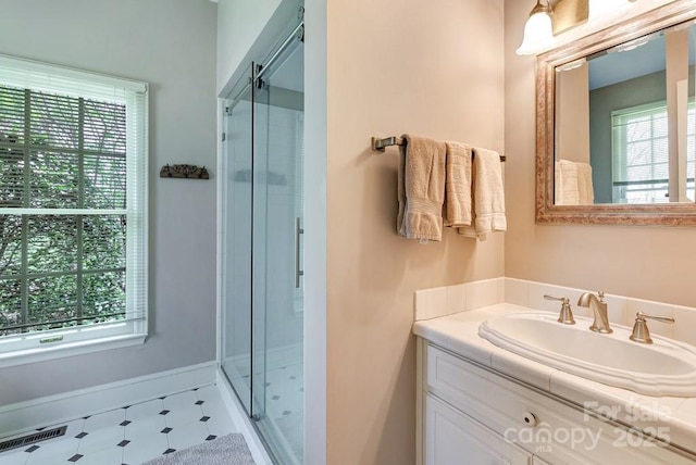 bathroom with a stall shower and plenty of natural light