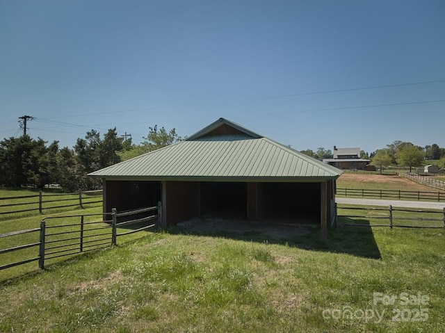 view of outbuilding featuring an exterior structure, an outdoor structure, and a view of rural / pastoral area