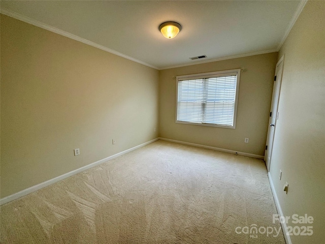carpeted empty room with ornamental molding and baseboards