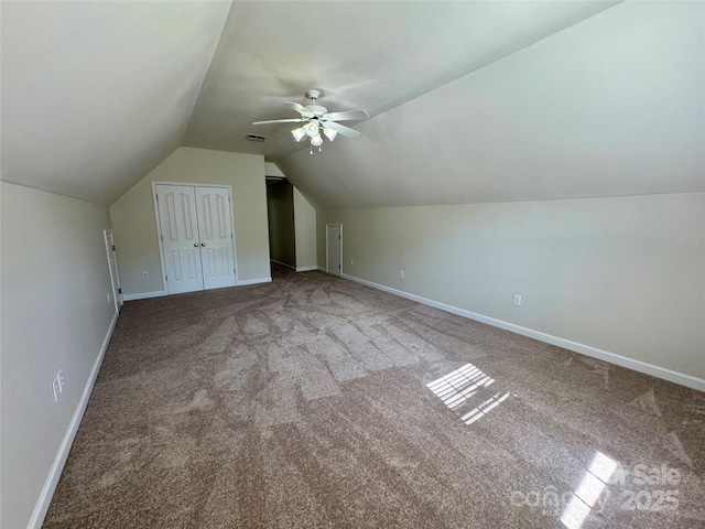 bonus room featuring carpet flooring, vaulted ceiling, a ceiling fan, and baseboards