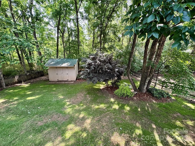 view of yard featuring a storage shed and an outbuilding