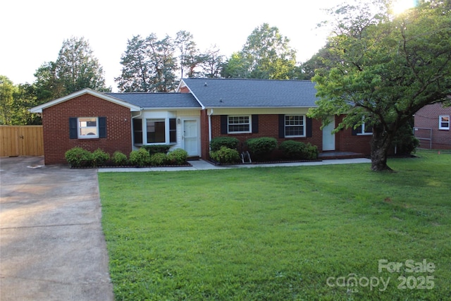 1421 Thompson Ave, Charlotte, NC 28216 - ranch-style home featuring brick siding, concrete driveway, and a shingled roof