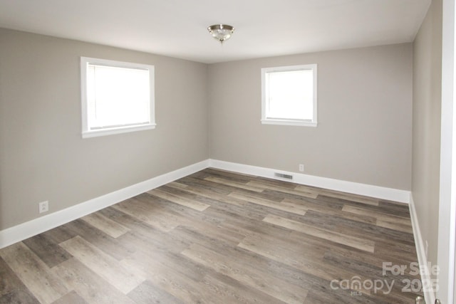 1421 Thompson Ave, Charlotte, NC 28216 - spare room featuring wood finished floors and baseboards