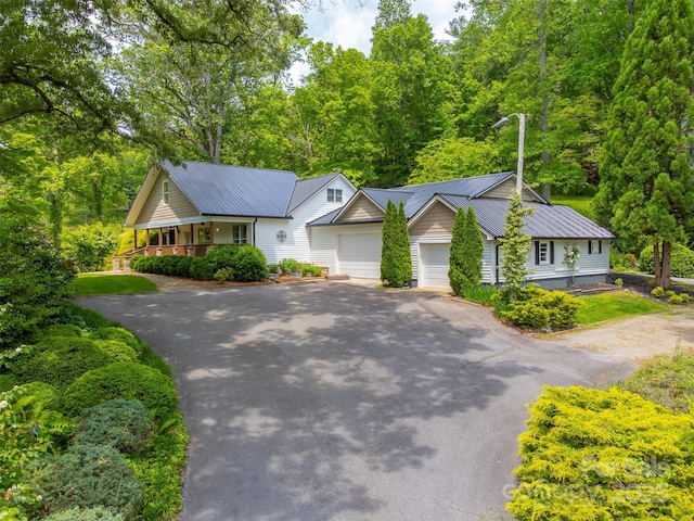 3407 Patton Rd, Franklin, NC 28734 - ranch-style house featuring asphalt driveway, covered porch, an attached garage, and metal roof